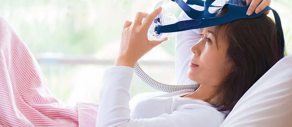 Woman using CPAP machine
